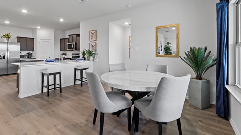 450 Lucky Lane at Bluff Springs in Ferris, TX dining area with hardwood flooring and views of the kitchen