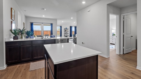 450 Lucky Lane at Bluff Springs in Ferris, TX kitchen island with view of open concept downstairs area