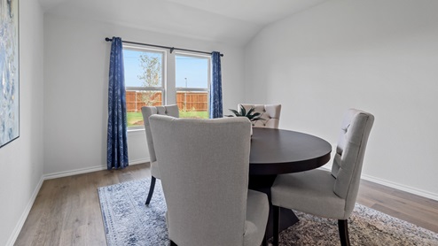 450 Lucky Lane at Bluff Springs in Ferris, TX primary bedroom with hardwood floors