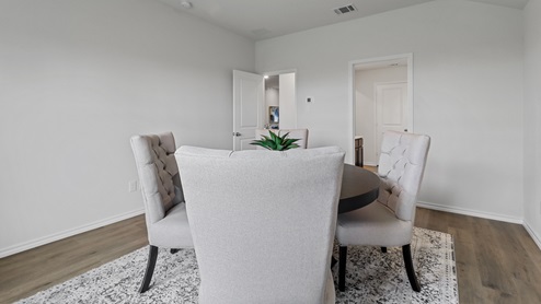 450 Lucky Lane at Bluff Springs in Ferris, TX primary bedroom with hardwood floors
