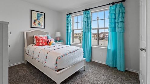454 Lucky Lane at Bluff Springs in Ferris, TX secondary bedroom with carpet and large windows providing natural light