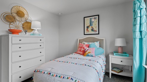 454 Lucky Lane at Bluff Springs in Ferris, TX secondary bedroom with carpet and large windows providing natural light