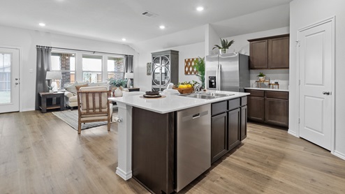 454 Lucky Lane at Bluff Springs in Ferris, TX kitchen area with hardwood floors and white counters