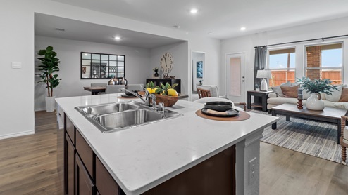 454 Lucky Lane at Bluff Springs in Ferris, TX kitchen island with view of open concept living area