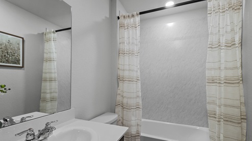 454 Lucky Lane at Bluff Springs in Ferris, TX secondary bathroom with white counters