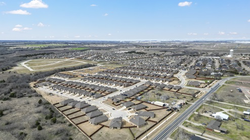 Aerial image of Bluff Springs in Ferris TX showing completed homes along with developing built homes