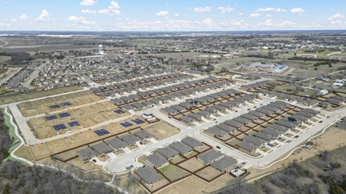 Aerial image of Bluff Springs in Ferris TX showing completed homes along with developing built homes