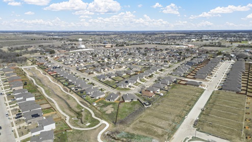Aerial image of Bluff Springs in Ferris TX showing completed homes along with developing built homes