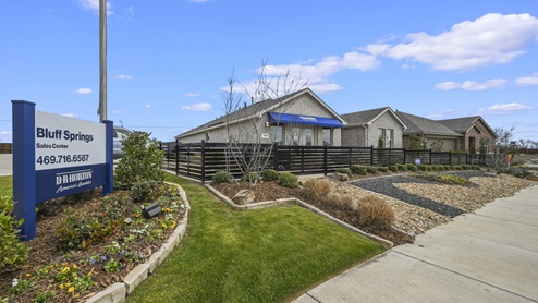 Model homes with view of Bluff Springs sign with contact information