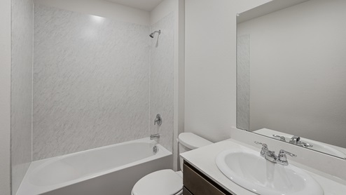 a bathroom with dark cabinets