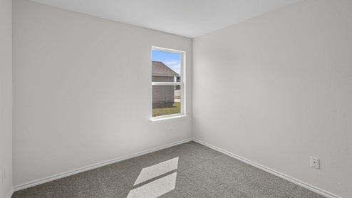 an empty bedroom with gray carpet and white walls
