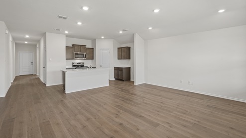 an open living room with white walls and wood floors