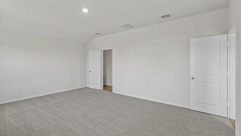 an empty bedroom with gray carpet and white walls