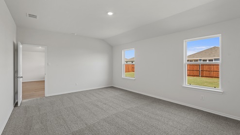 an empty bedroom with gray carpet and white walls