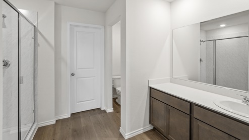 a bathroom with dark cabinets