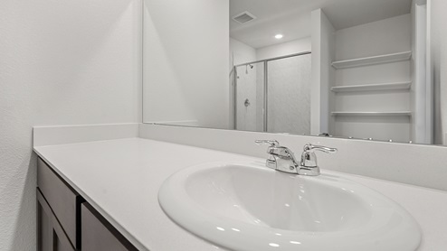 a bathroom with dark cabinets
