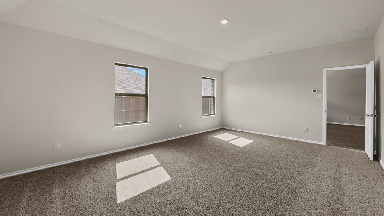 an empty bedroom with gray carpet and white walls