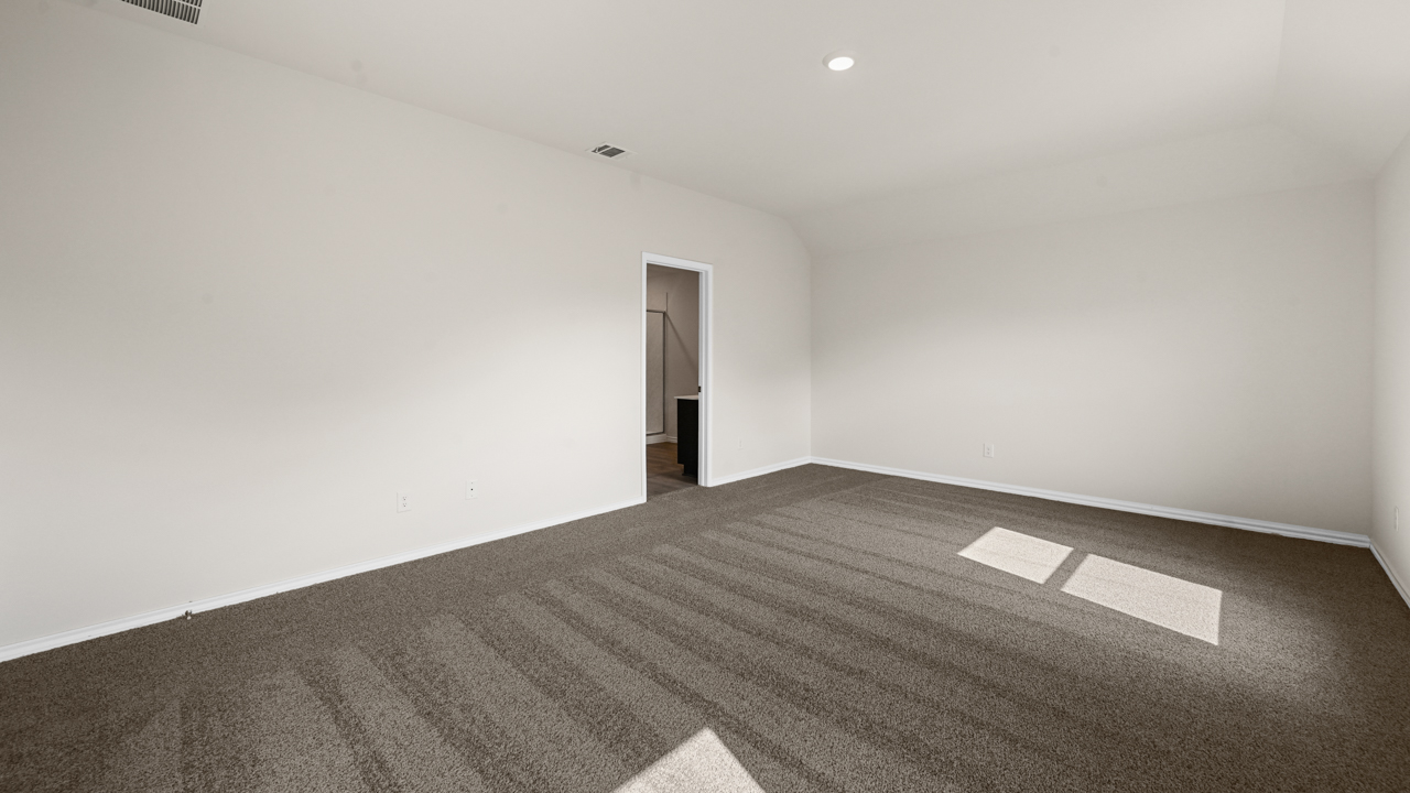 an empty bedroom with gray carpet and white walls