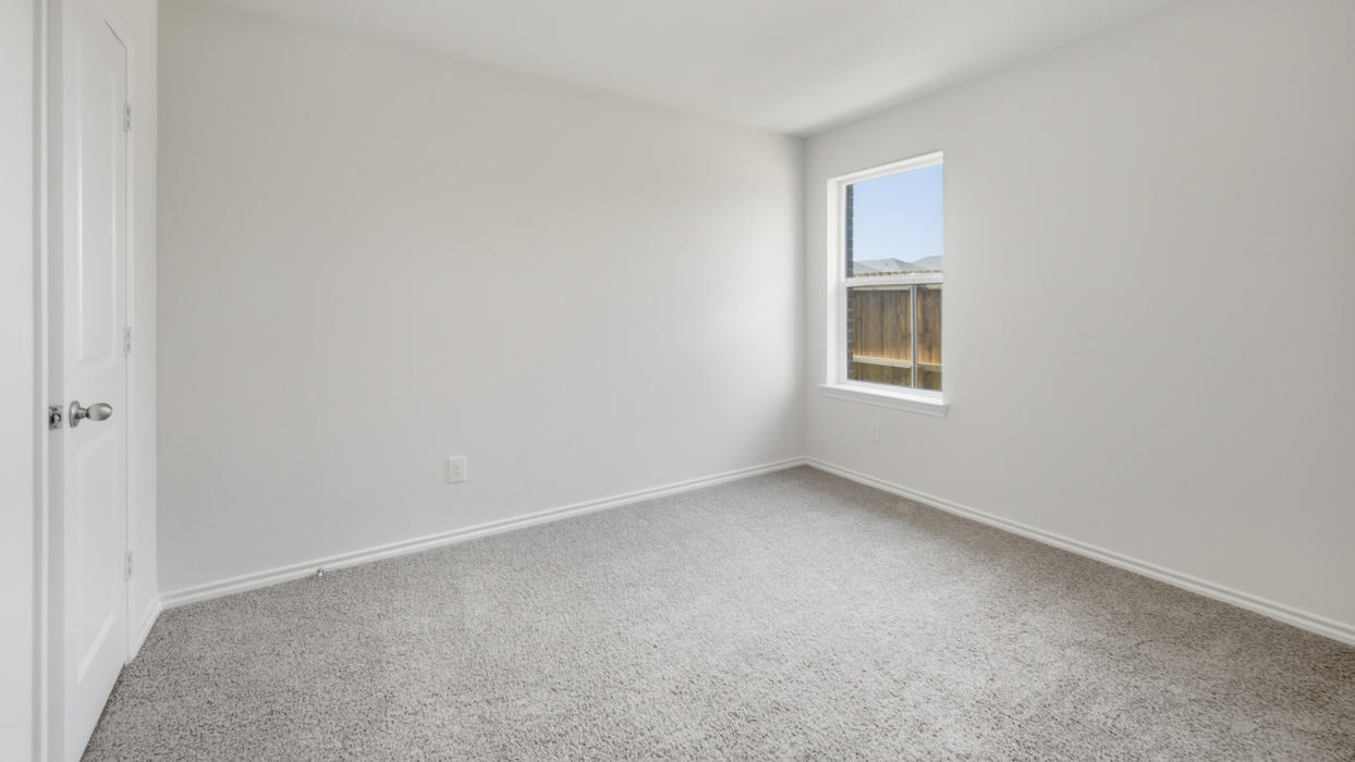 bedroom 2 with light grey carpet and natural lighting