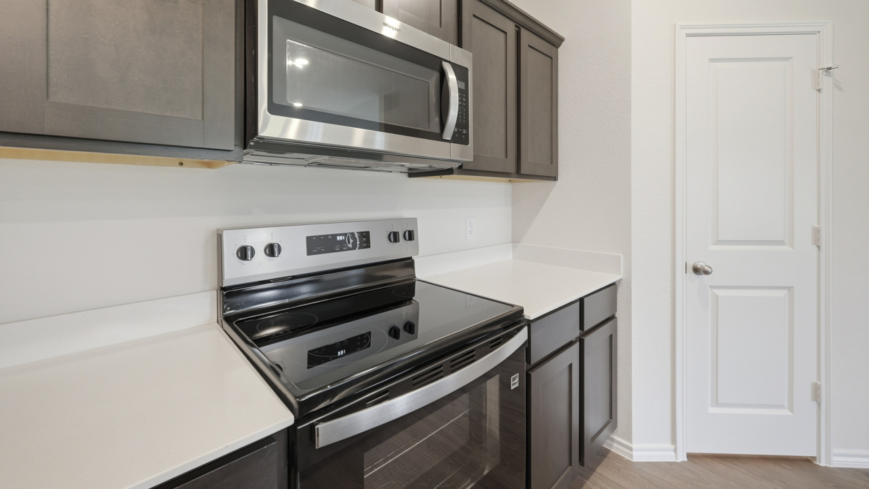 kitchen view showing electric stove top and pantry