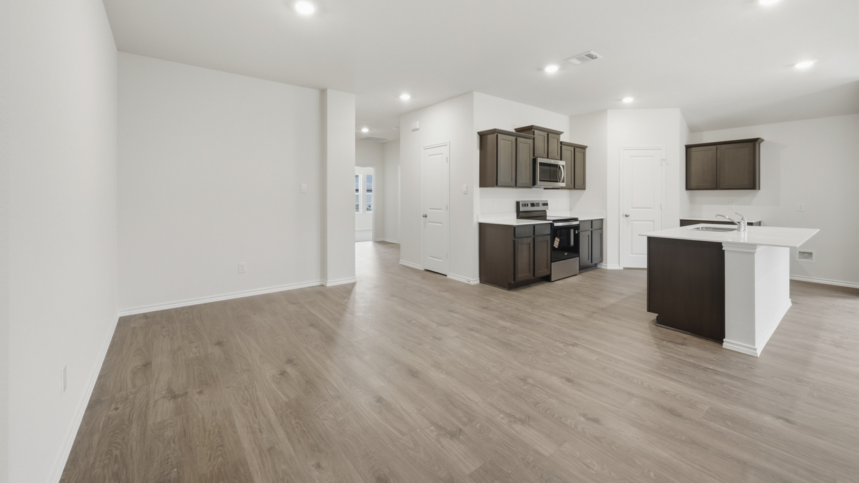 overview of kitchen and living room showing hallway entrance