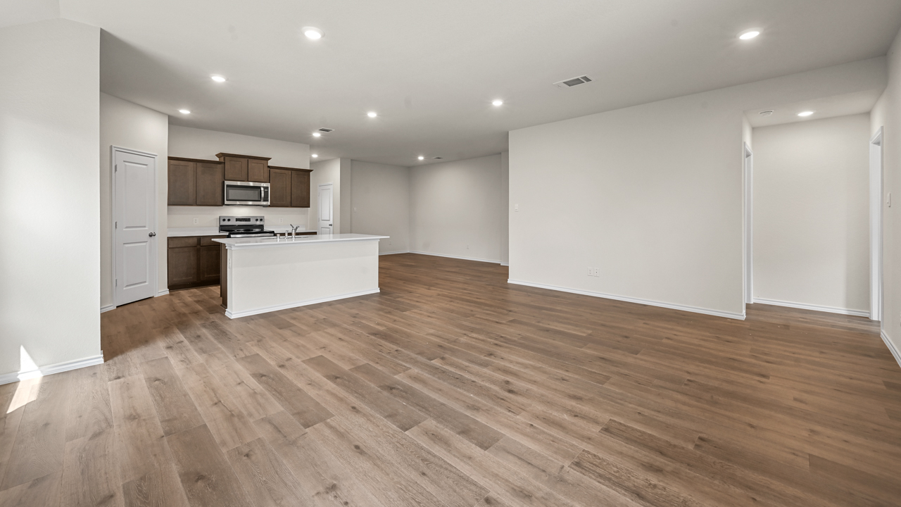 an open living room with wood floors and white walls