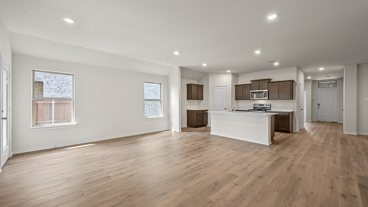 an open living room with wood floors and white walls