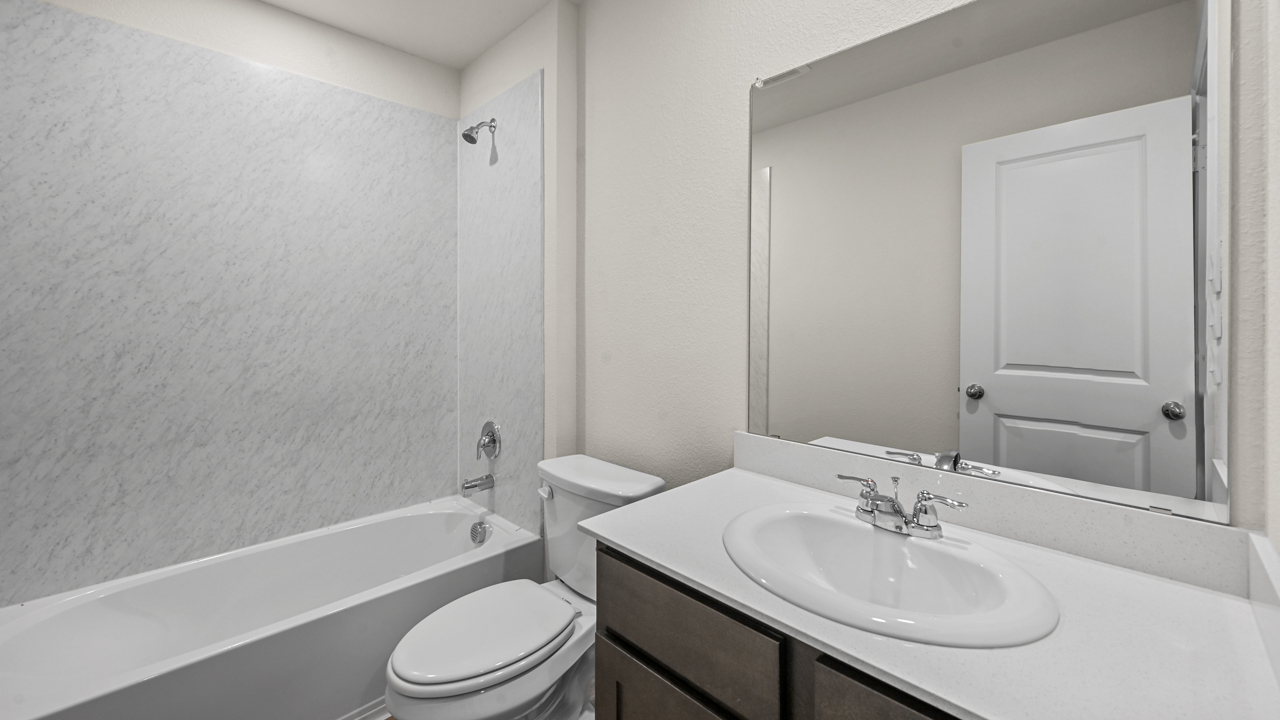 a bathroom with dark cabinets