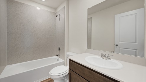 a bathroom with dark cabinets