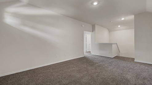 upstairs gameroom with gray carpet and white walls