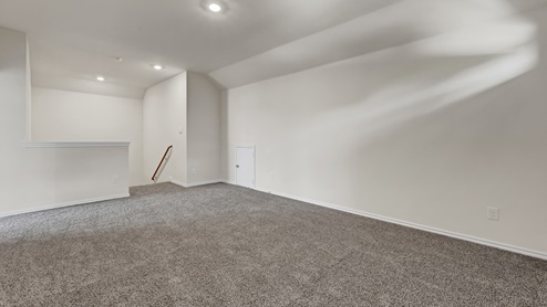 upstairs gameroom with gray carpet and white walls