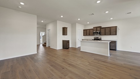 an open living area with wood floors and white walls