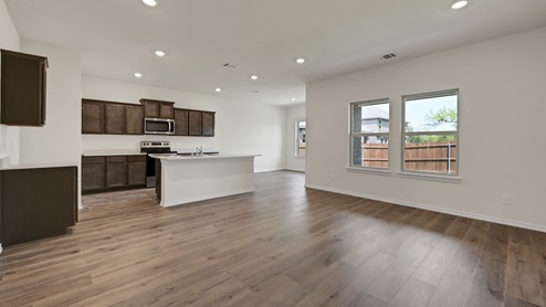 an open living area with wood floors and white walls