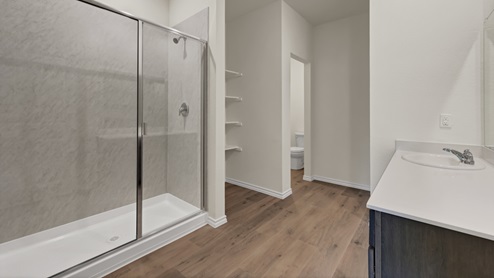 a bathroom with dark cabinets