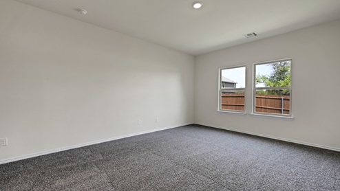 an empty bedroom with gray carpet and white walls
