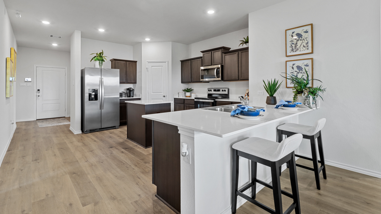 kitchen area with dark cabinets and light counters