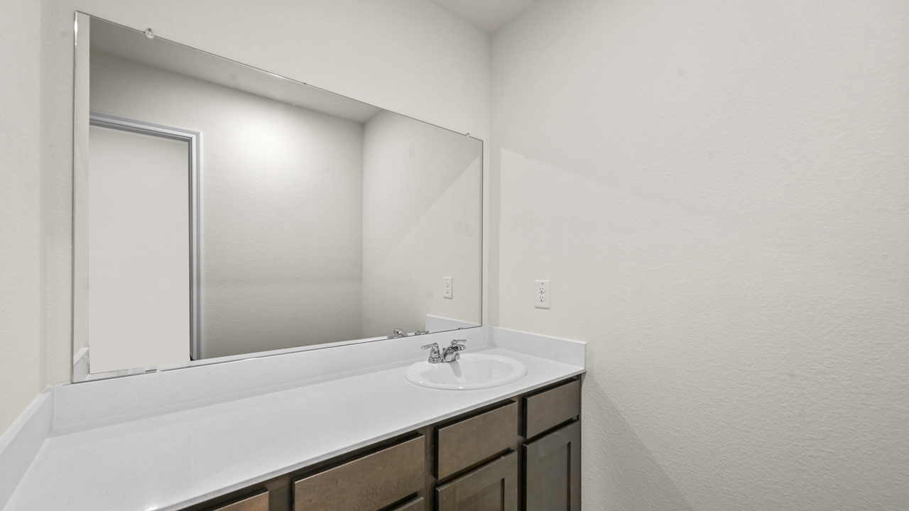 a bathroom with dark cabinets