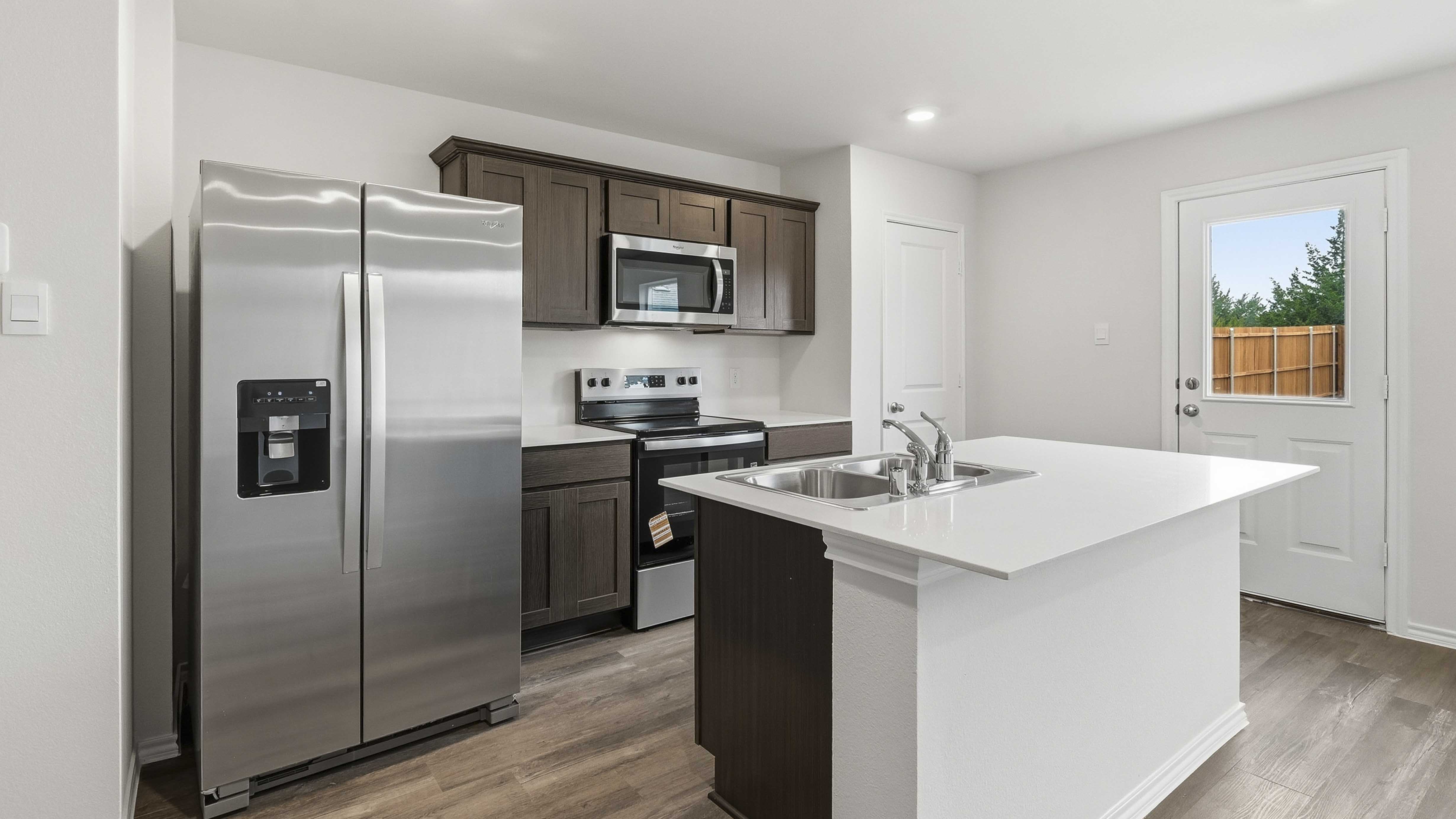 kitchen area with hardwood floors white counters and dark cabinets
