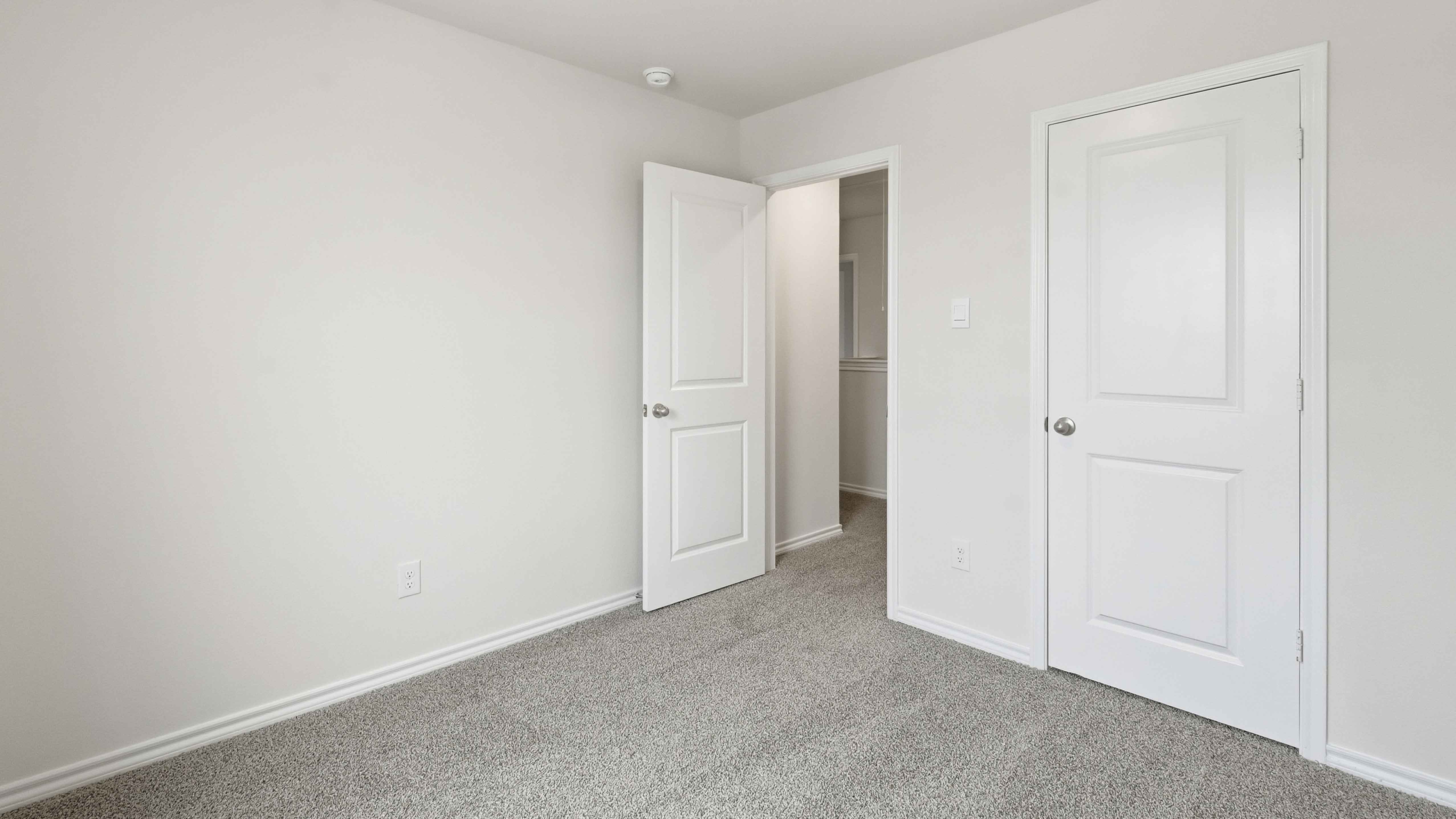 secondary bedroom with carpet and large window