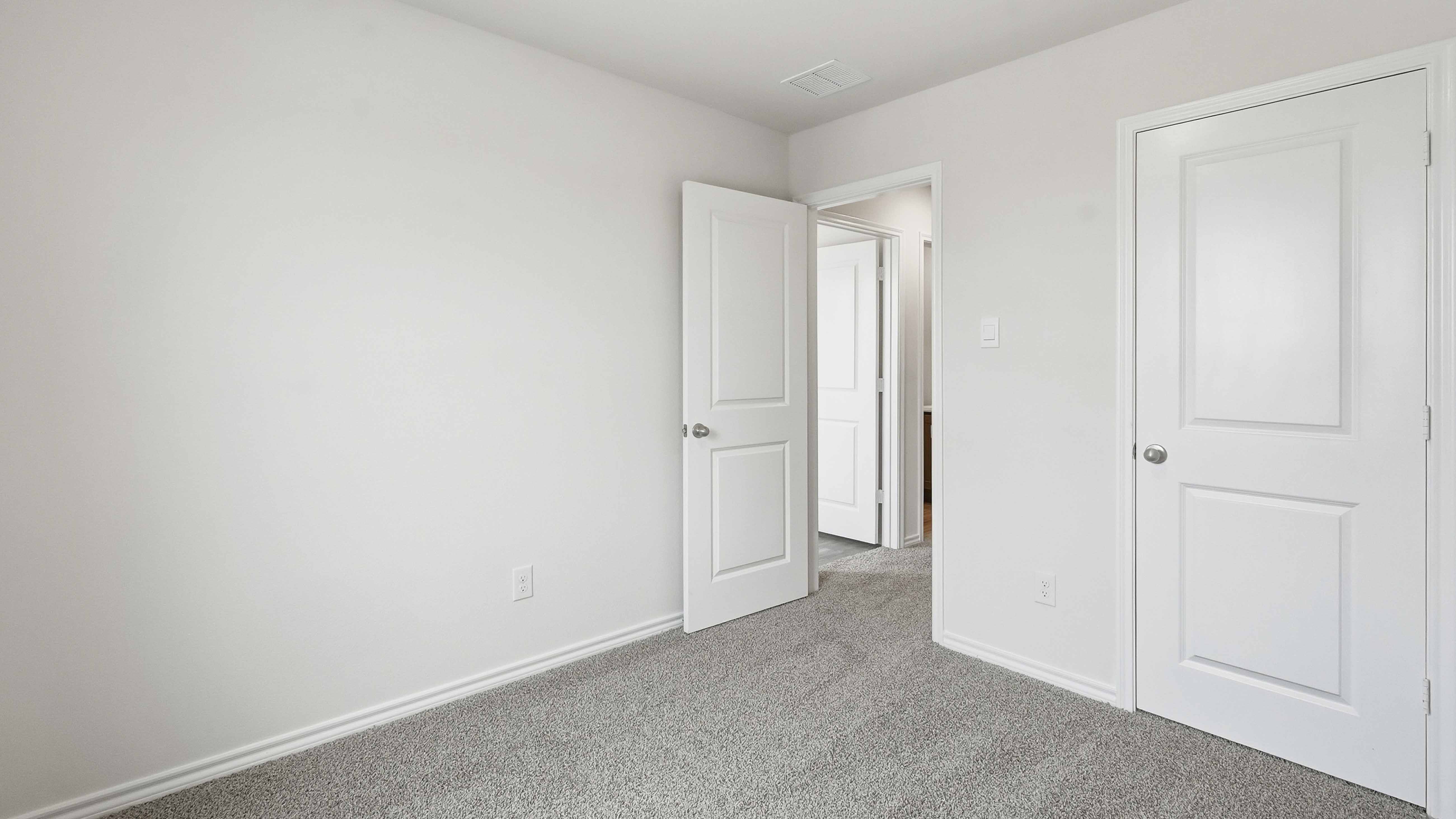 secondary bedroom with carpet and large window
