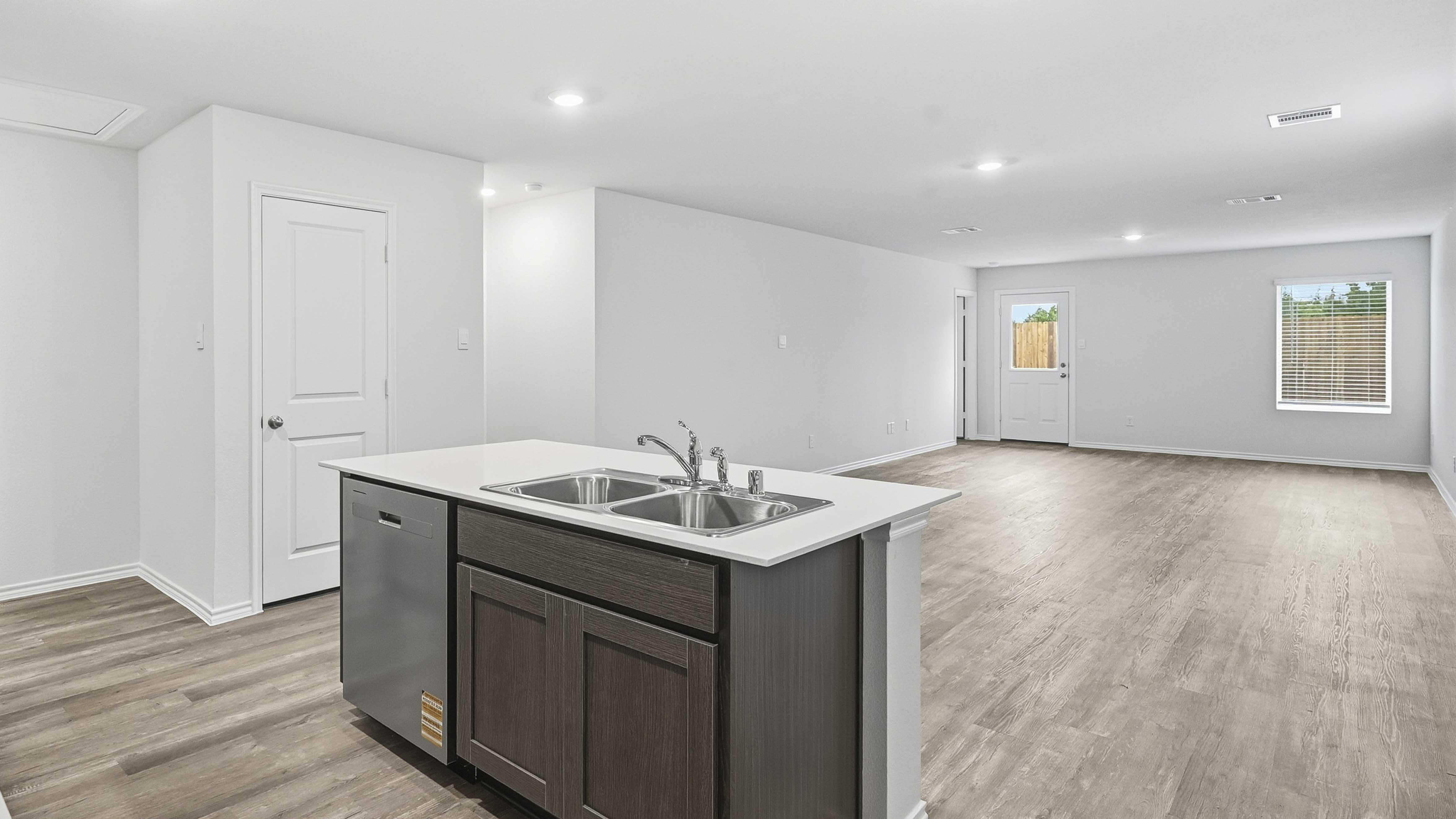 kitchen area with hardwood floors white counters and dark cabinets