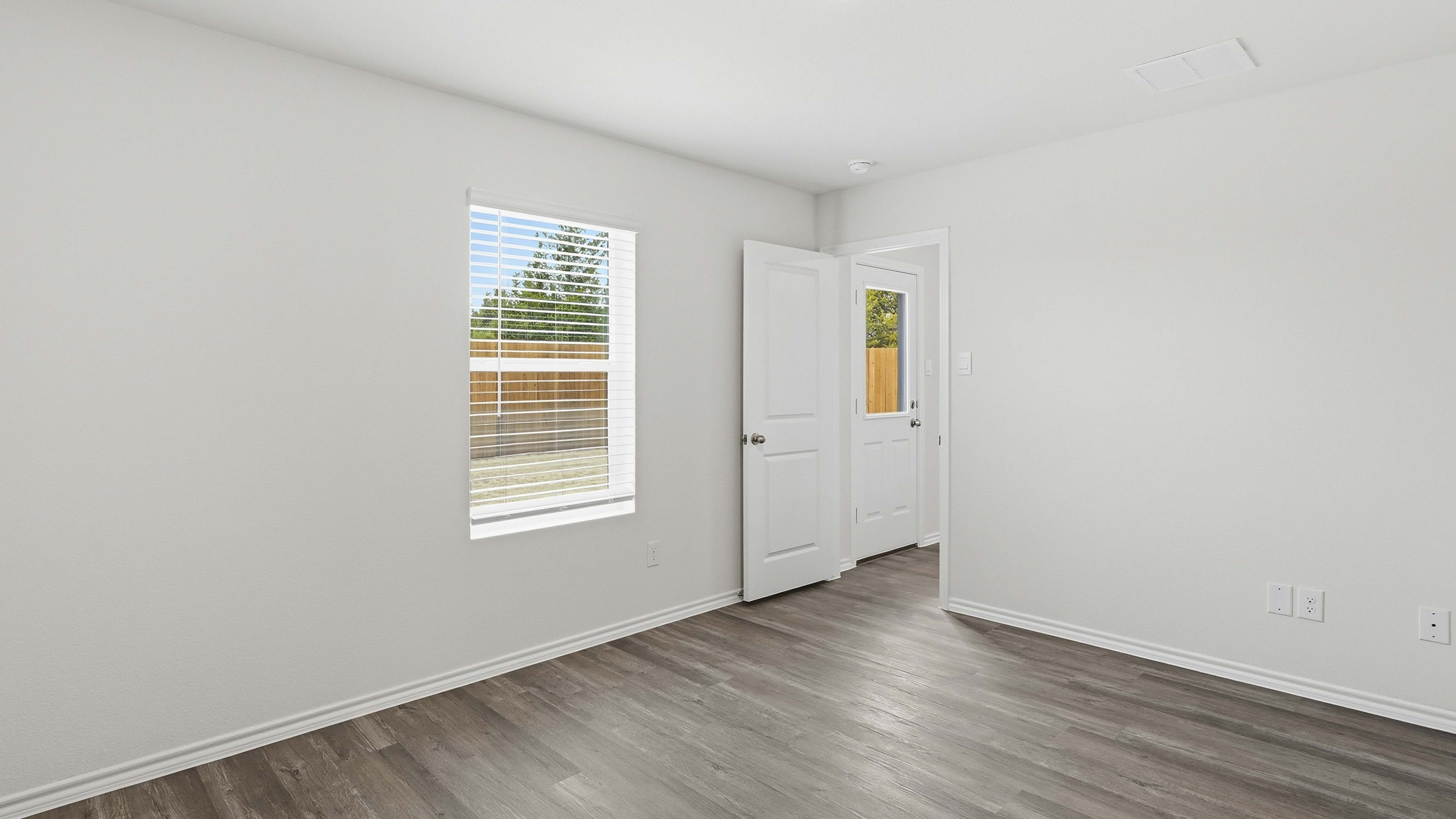 primary bedroom with hardwood floors