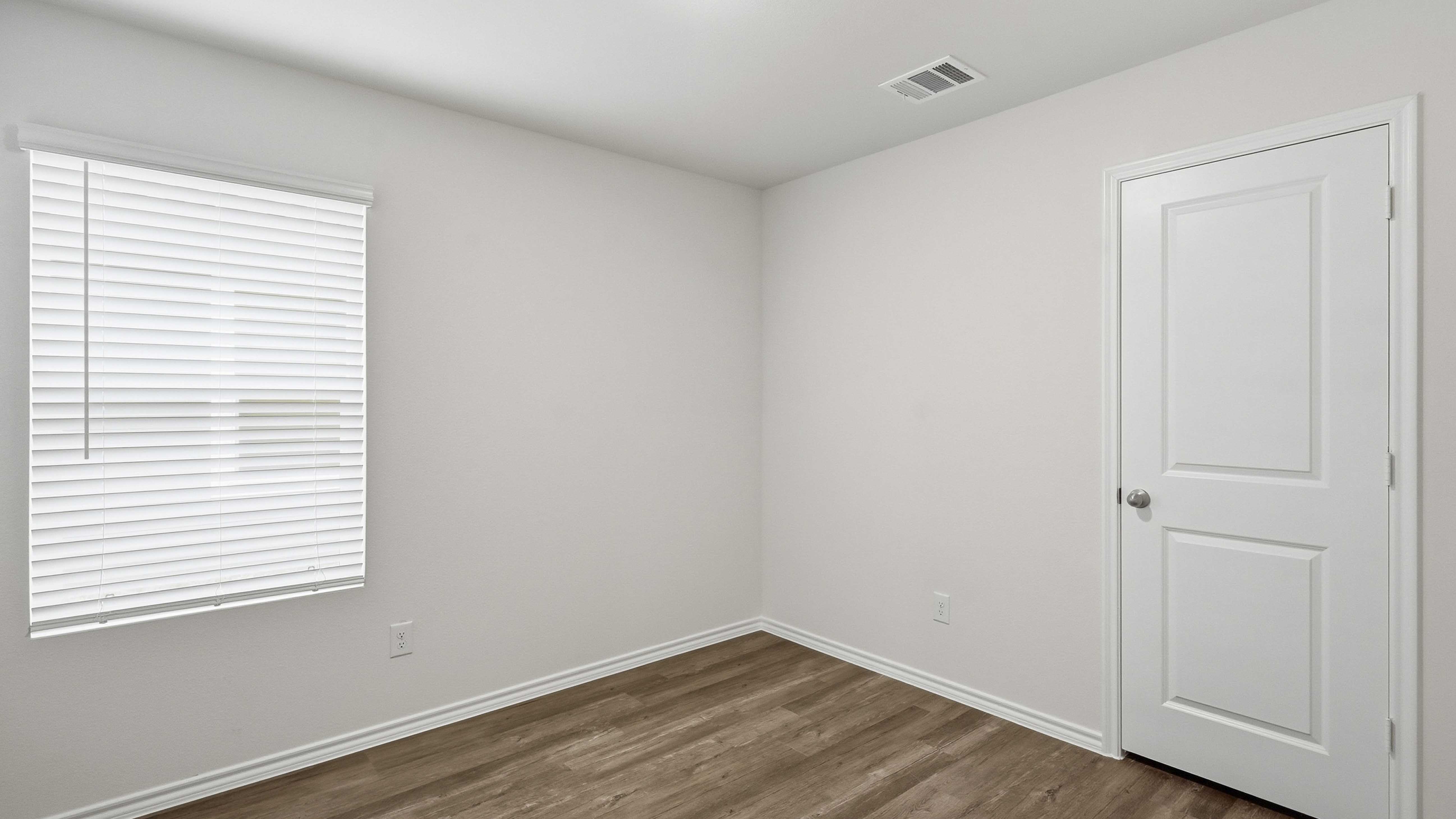 secondary bedroom with large window providing natural light
