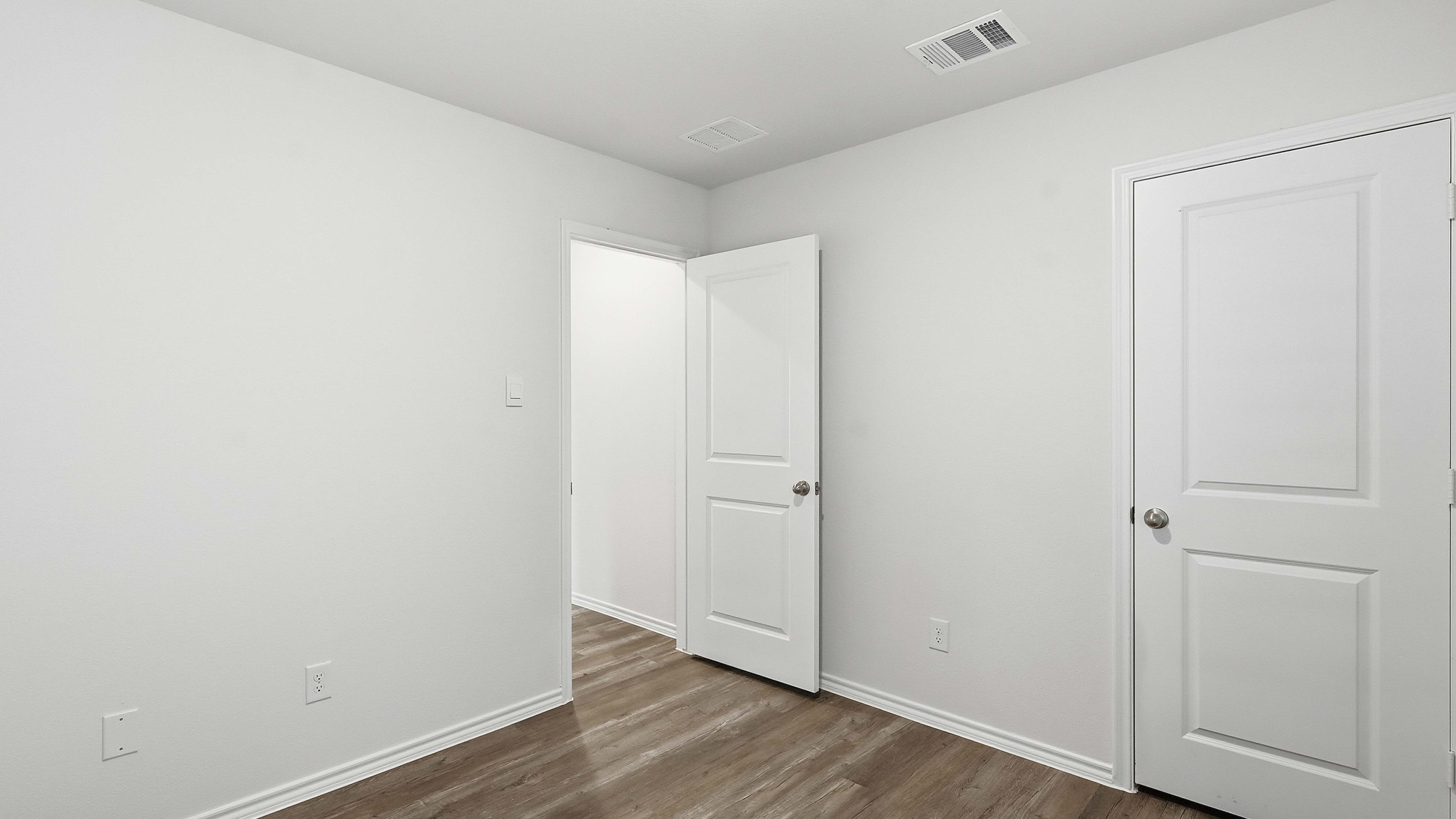 secondary bedroom with large window providing natural light