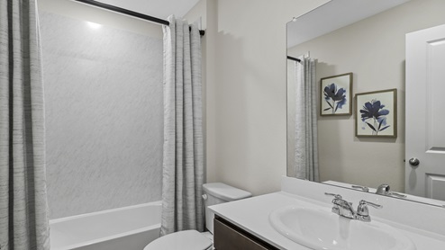 Bathroom with garden tub and white counter vanity and mirror