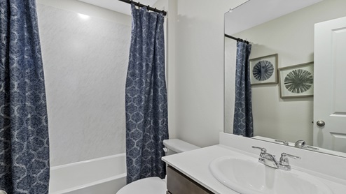 Bathroom with garden tub and white counter vanity and mirror