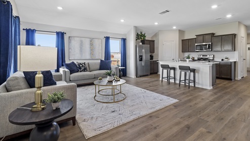 Living area with windows and open concept into kitchen