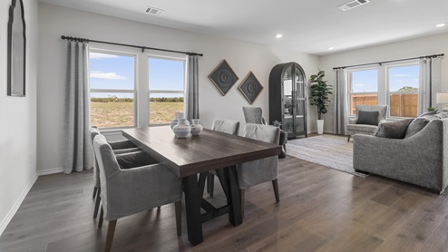 Dining area with large window with open concept into living room