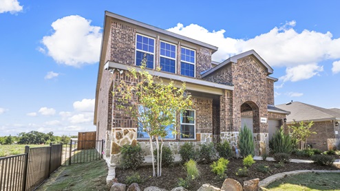 Two story model home with beautiful landscaping and covered patio