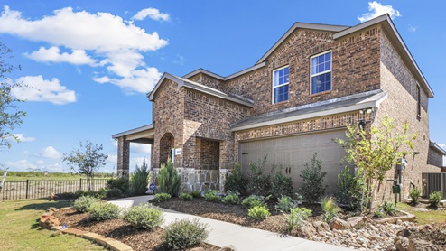 Two story model home with beautiful landscaping and covered patio